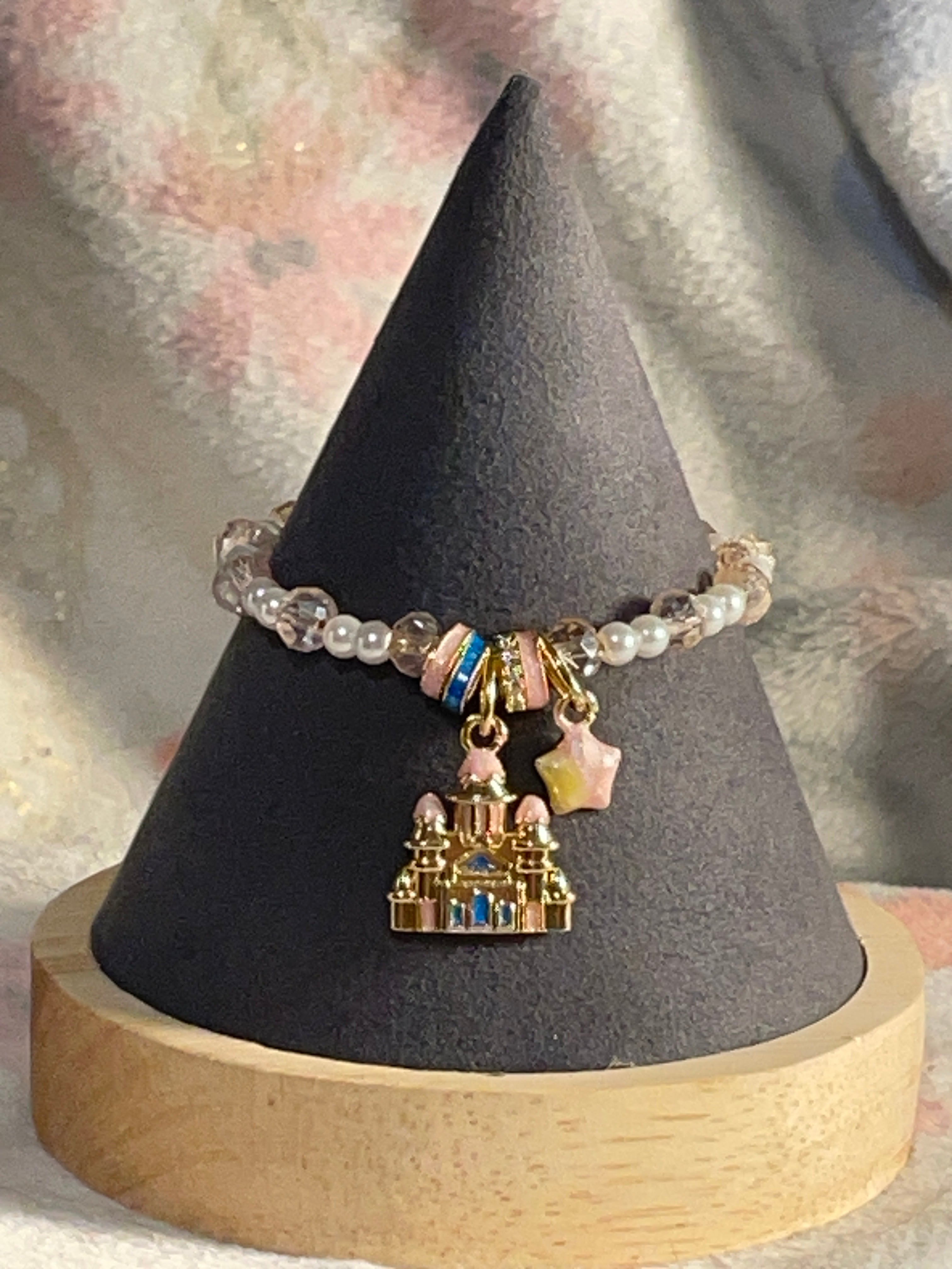 Pearl with a light pink with the gold, pink blue castle