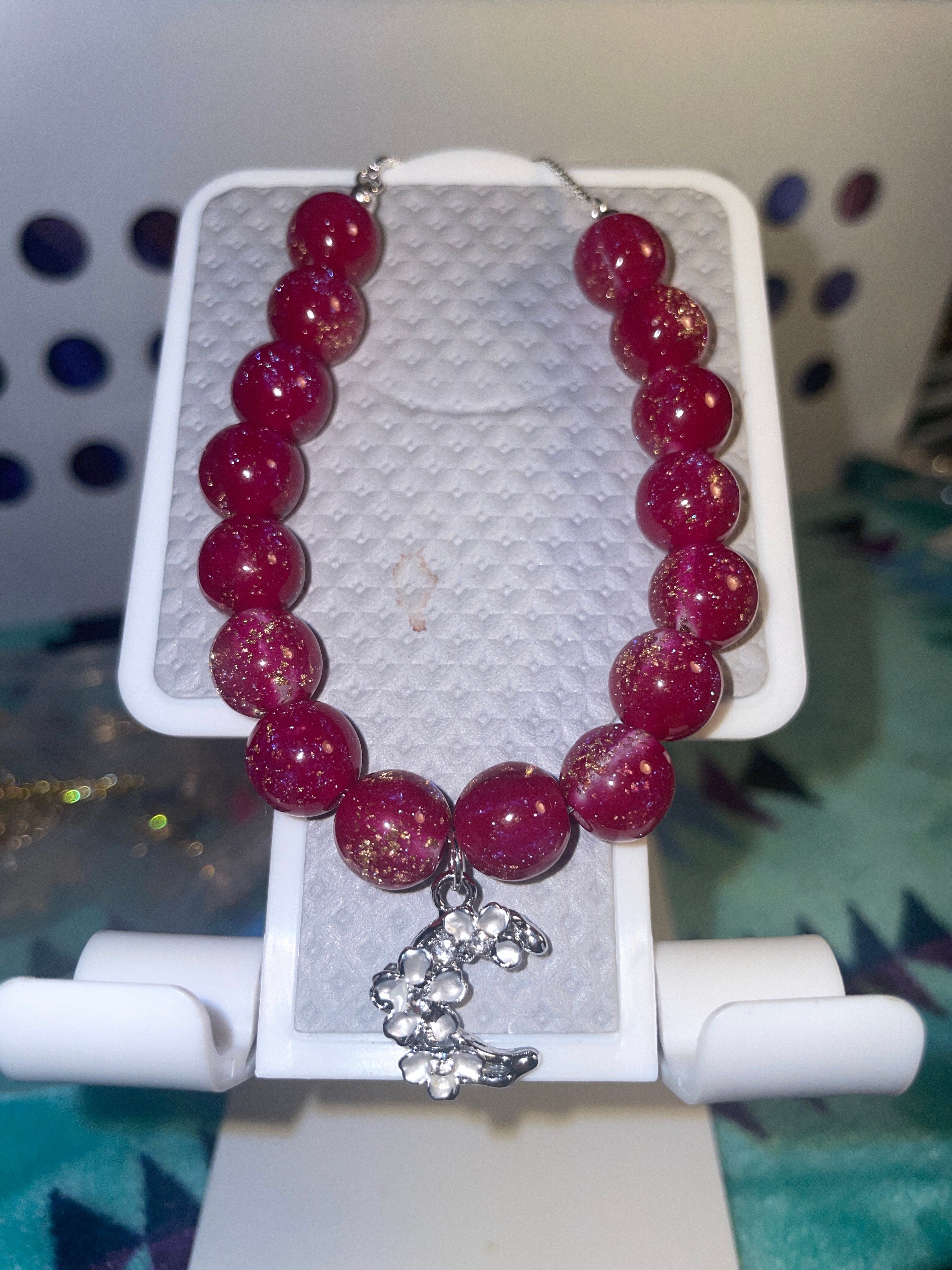 Maroon/speck of gold bracelet with the moon for a charm ￼