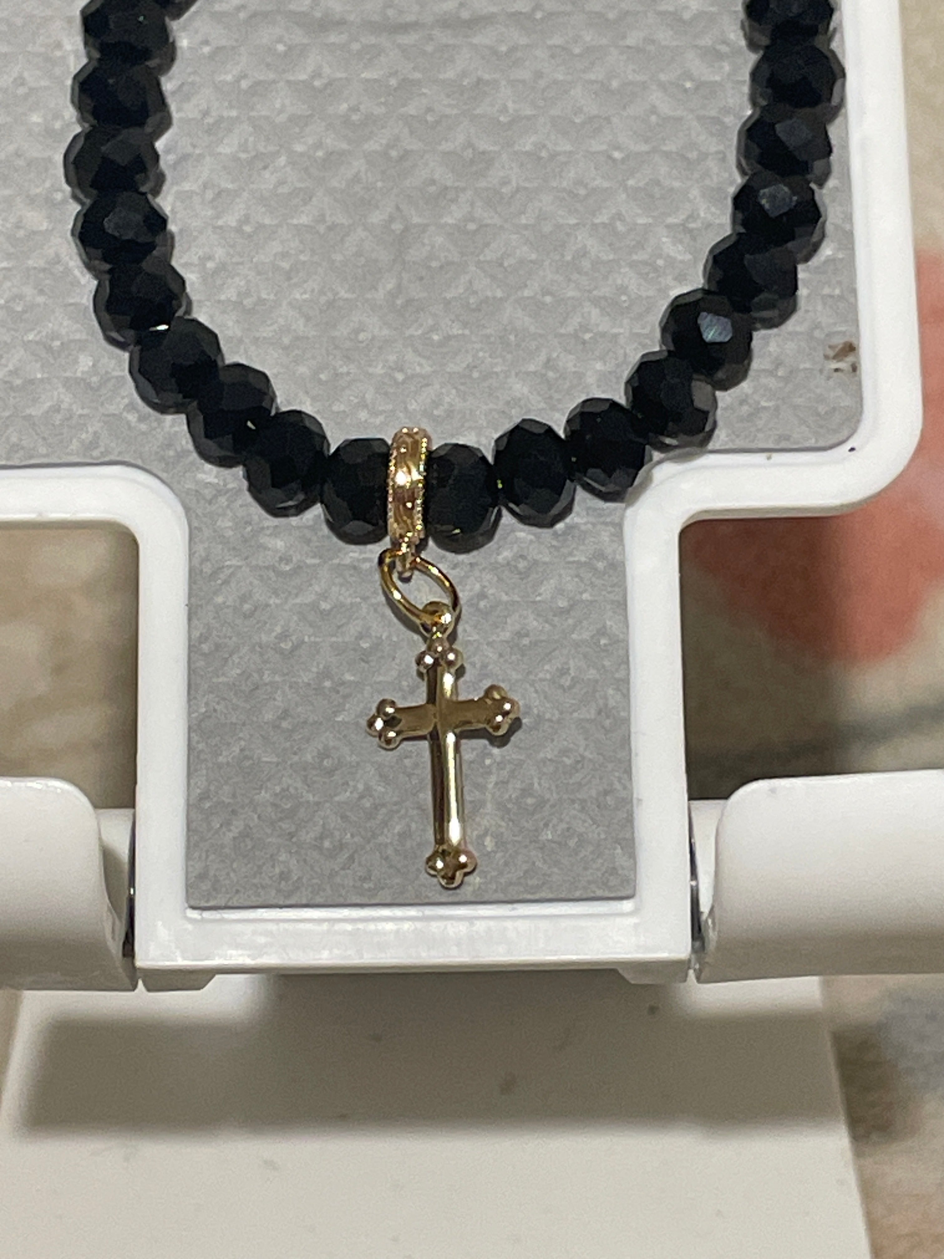 Black glass beads with gold plated cross
