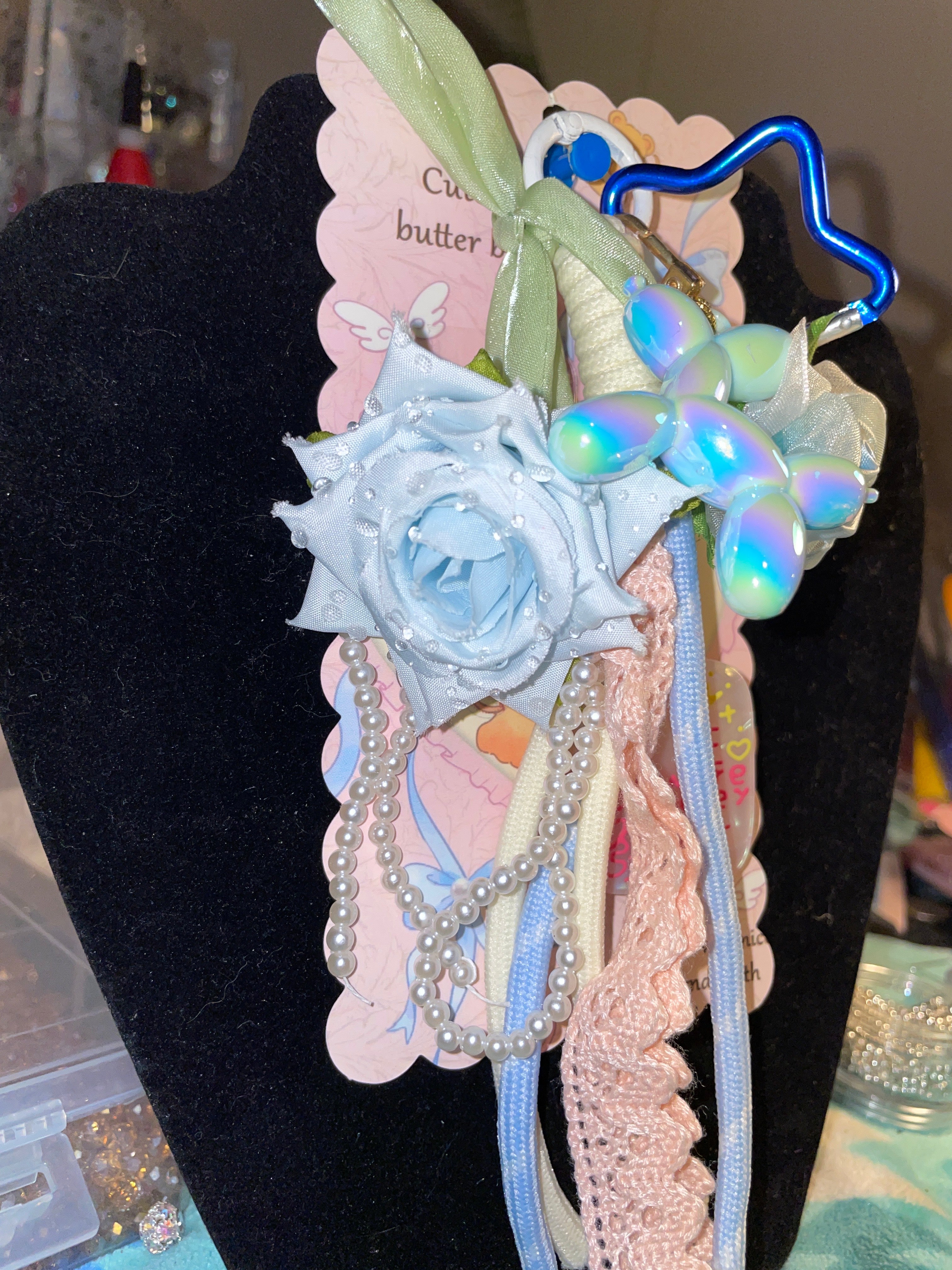 Light blue rose with pearls featuring light, blue balloon dog keychain ￼