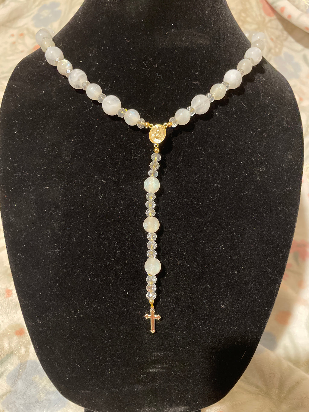 White beads/rosary with gold plated cross.